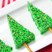 Christmas trees on rectangular white plate, on red background.