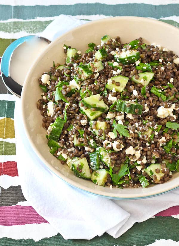 Overhead of lentil salad in shallow white dish.
