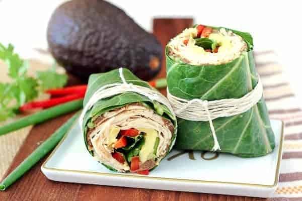 Switch up your wrap game! This southwestern collard wrap envelopes chicken, beans, red peppers, avocados, and more in a crunchy, satisfying, and colorful wrap. Get the recipe on RachelCooks.com! 