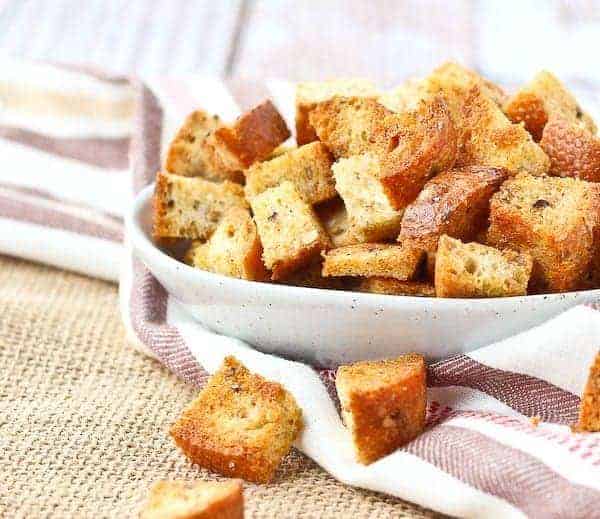 Croutons spilling out of a small white bowl.