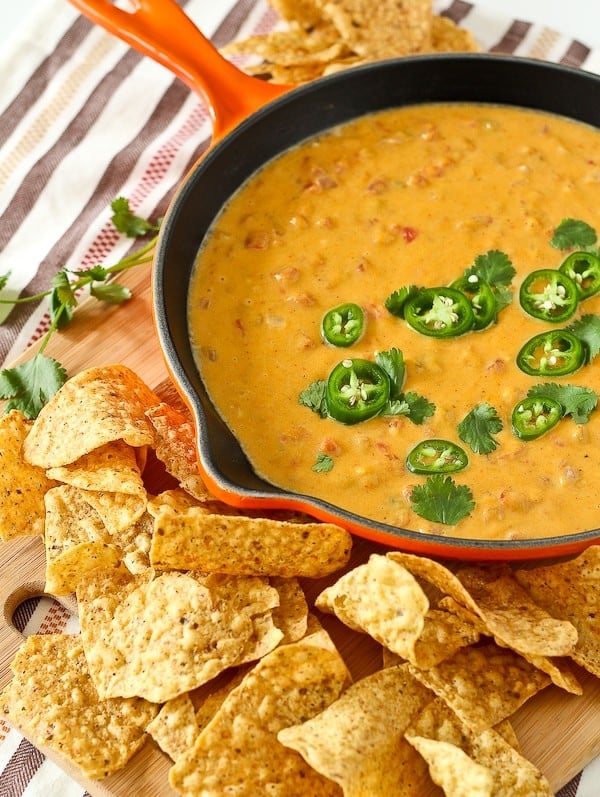 Healthy queso dip in an orange frying pan.