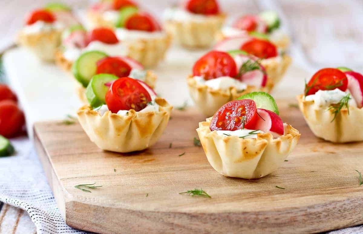 Phyllo cups with cream cheese, tomato, radish, cucumber, dill.