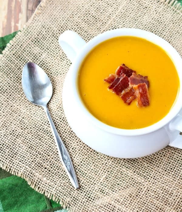 Warm and soothing, this squash soup with bacon is easy to make and perfect year-round. You won't be able to resist the crispy bacon on top! Get the easy butternut squash soup on RachelCooks.com!