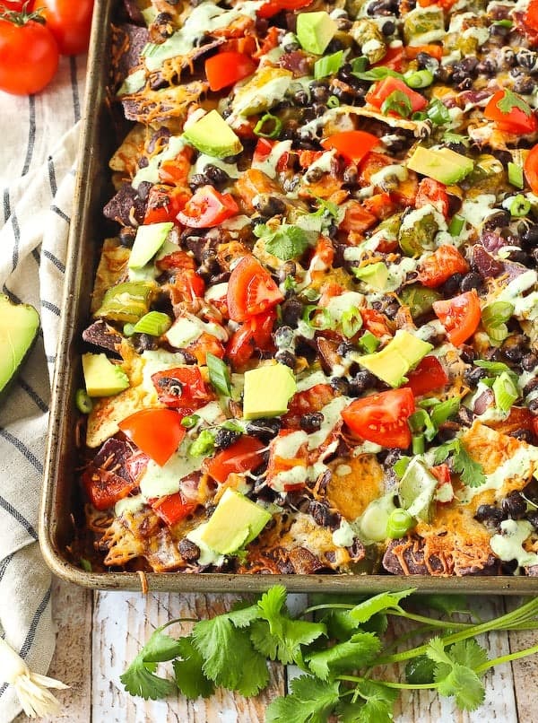 Words cannot express how badly you need these vegetarian nachos in your life. They're great on their own but the creamy cilantro lime drizzle puts them over the top! Get the recipe on RachelCooks.com!
