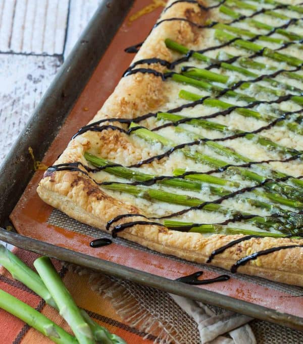 Perfect for spring, this Asparagus Gruyère Tart is a show-stopping addition to any brunch or appetizer table. You won't believe how easy it is to make! 