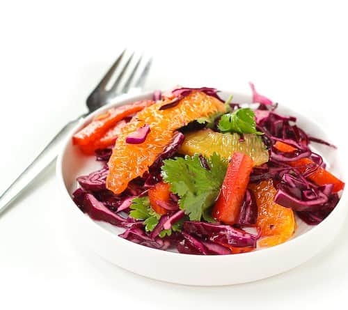 Refreshing and bright, this Red Cabbage Salad Recipe with Honey Lime Dressing is the perfect side to a heavy meal of Mexican food. It's even great on top of tacos! Get the easy recipe on RachelCooks.com!