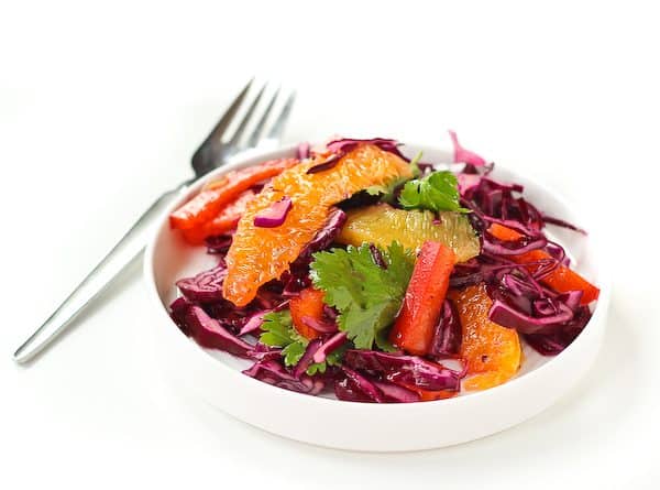 Refreshing and bright, this Red Cabbage Salad Recipe with Honey Lime Dressing is the perfect side to a heavy meal of Mexican food. It's even great on top of tacos! Get the easy recipe on RachelCooks.com!