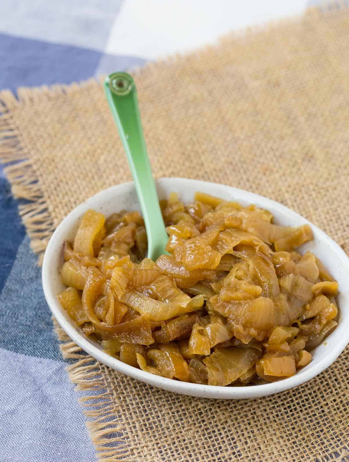 Slow cooker caramelized onions in a small ovel bowl.