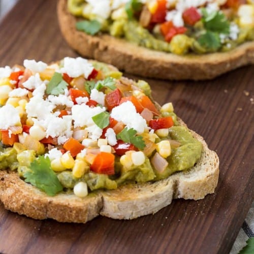 This southwestern guacamole toast is going to be your lunch go-to meal. It's easy to make, filling, and packed full of flavor thanks to peppers, sweet corn, lime, and cilantro. Get the avocado toast recipe on RachelCooks.com!
