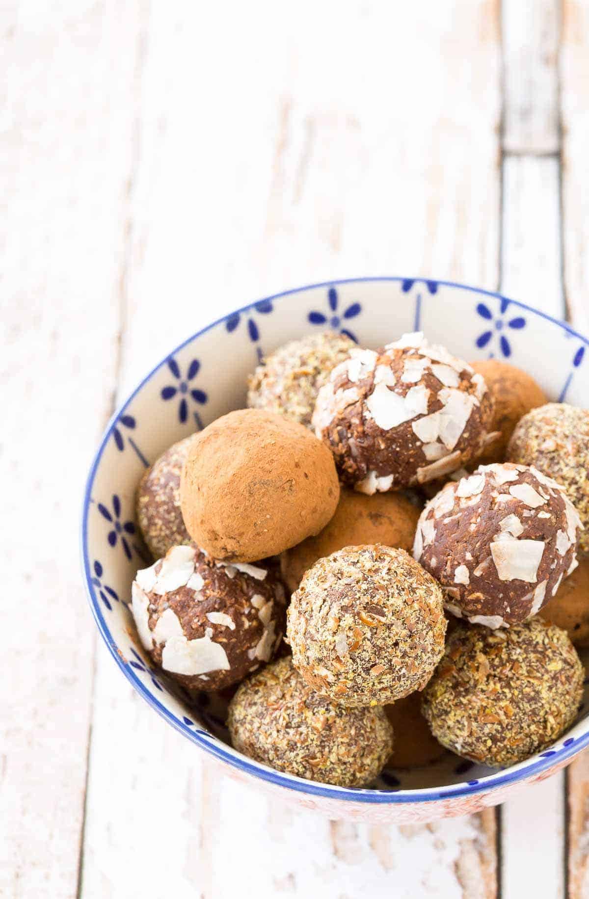 Chocolate nut-free energy balls in a blue and white bowl.