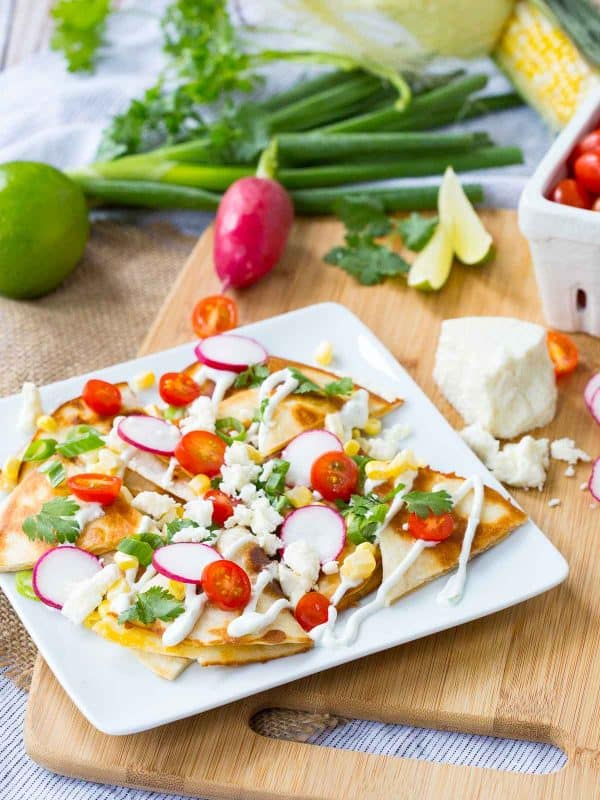 How about we put the cheese inside the “chips” and use quesadillas as the base for some summer-inspired quesadilla nachos? The result is incredible!