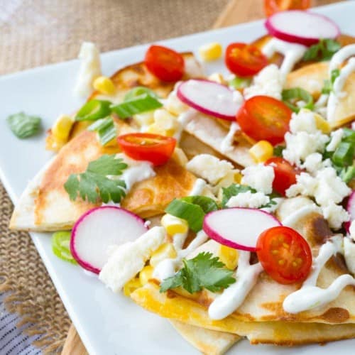 How about we put the cheese inside the “chips” and use quesadillas as the base for some summer-inspired quesadilla nachos? The result is incredible!