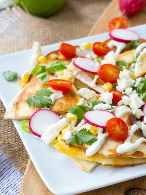 How about we put the cheese inside the “chips” and use quesadillas as the base for some summer-inspired quesadilla nachos? The result is incredible!