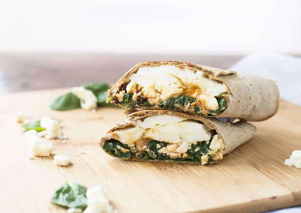 Egg white wrap cut in half with the halves stacked on top of each other.