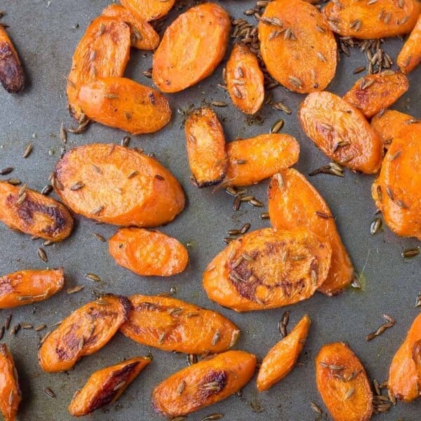 Tired of plain carrots? These roasted carrots with cumin are going to blow your mind with their punch of flavor. A fantastic, unique and healthy side dish. Get the recipe on RachelCooks.com!