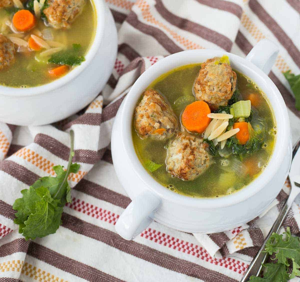 Overhead of meatball soup in bowls.