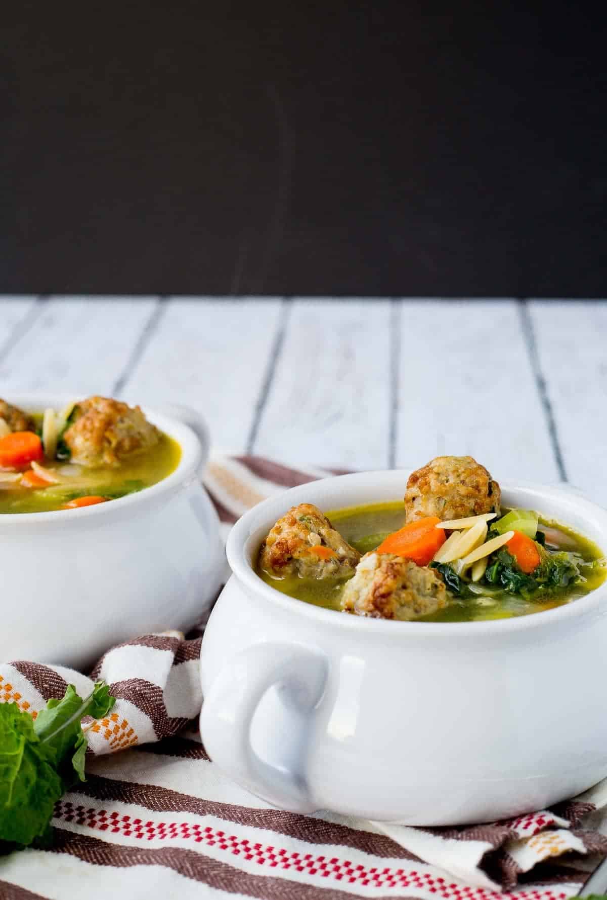 A couple of bowls filled with meatball soup.