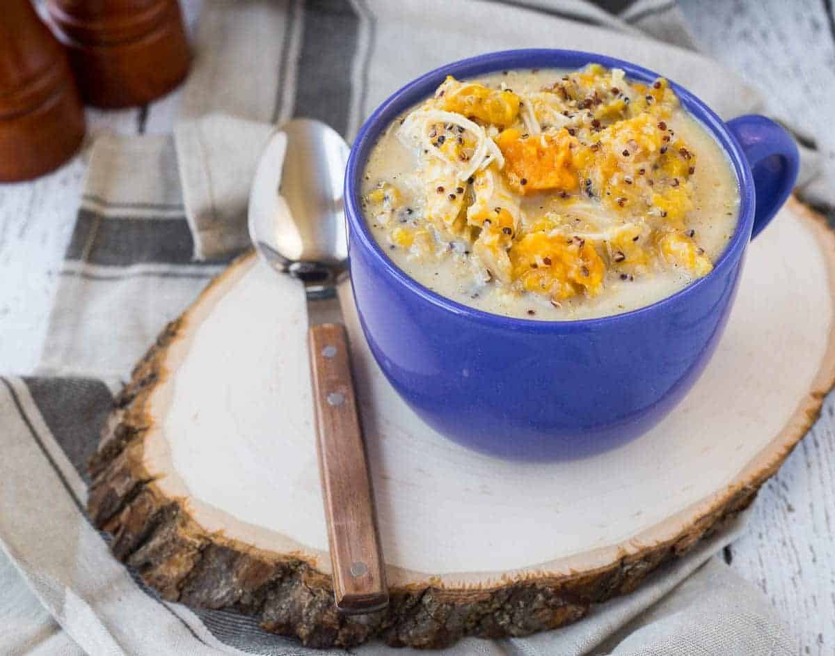 Soup in blue mug with spoon.