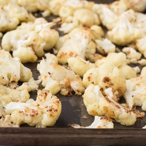 This Parmesan Roasted Cauliflower is going to become your new favorite way to eat cauliflower - it's flavorful, crispy, and so easy to prepare! Get the recipe on RachelCooks.com!