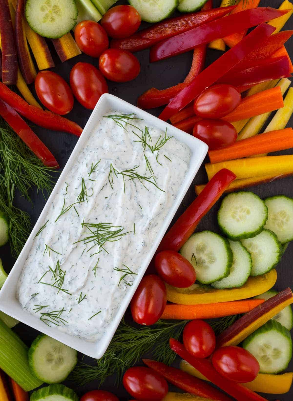 Dill vegetable dip surrounded by vegetables.