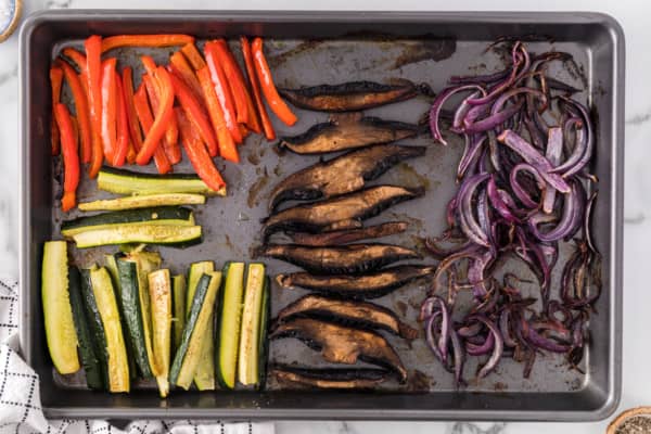 Roasted vegetables on a sheet pan.