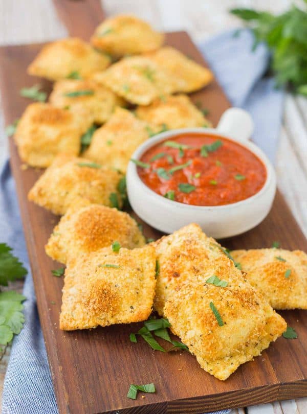 Baked not fried, these toasted cheese ravioli are the perfect game day snack or appetizer. You won't be able to stop snacking on them! Get the recipe on RachelCooks.com!