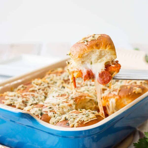 Pepperoni, sauce, and cheese sandwiched between soft rolls and baked -- these pepperoni pizza sliders will be the hit of your party! Get the fun game day recipe on RachelCooks.com!