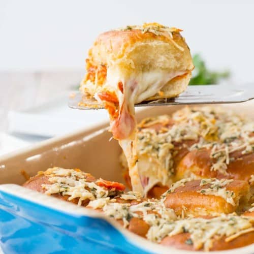 Pepperoni, sauce, and cheese sandwiched between soft rolls and baked -- these pepperoni pizza sliders will be the hit of your party! Get the fun game day recipe on RachelCooks.com!