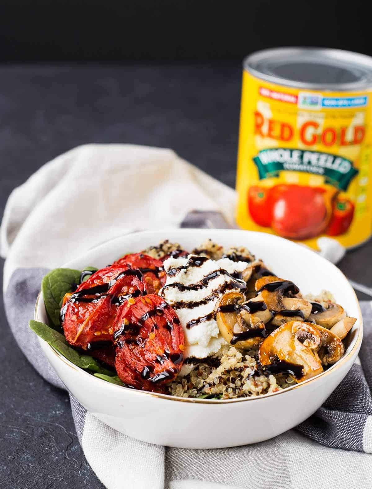 Arranged salad in white bowl, with can of Red Gold tomatoes in background.