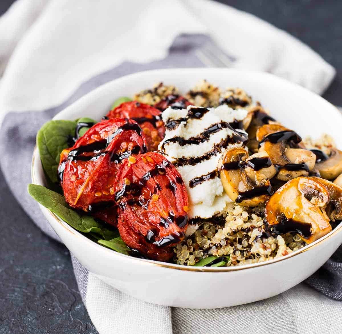 Front closeup of salad in bowl, on white linen dish towel.