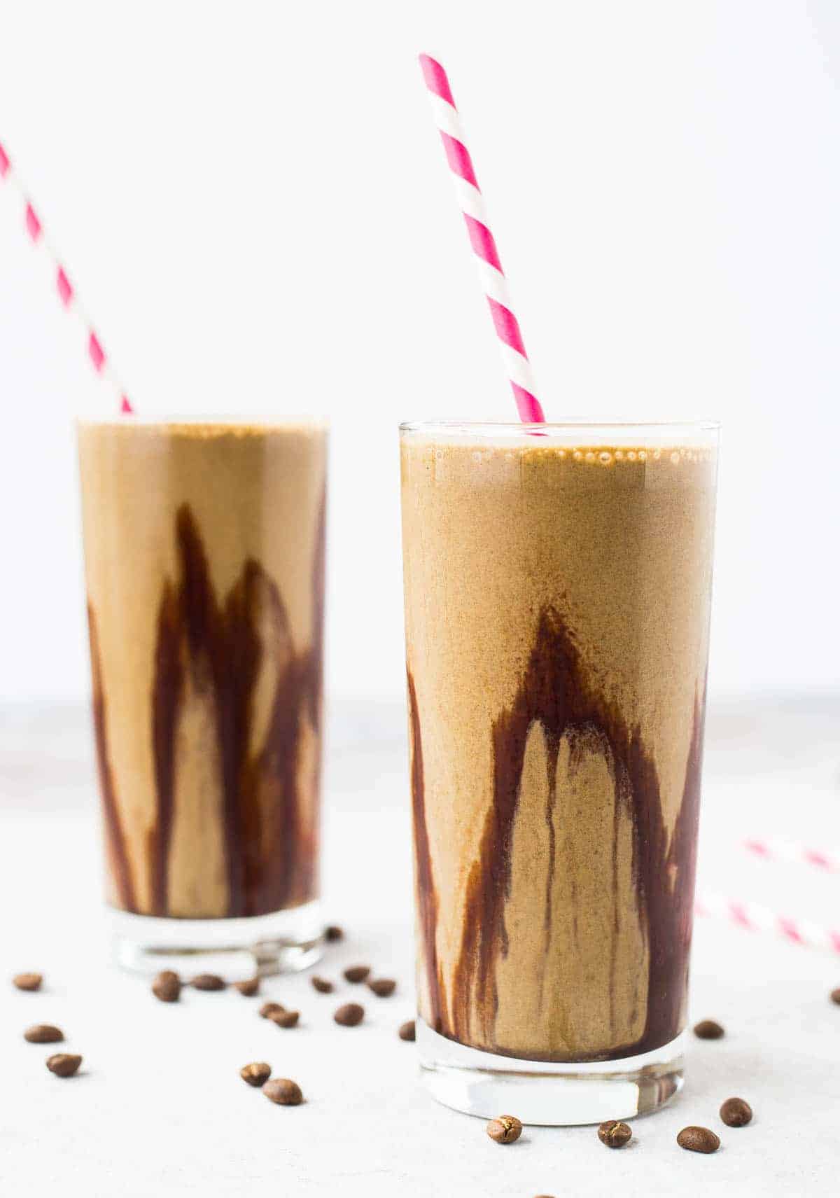 Mocha protein shake with chocolate syrup lining the glass. 