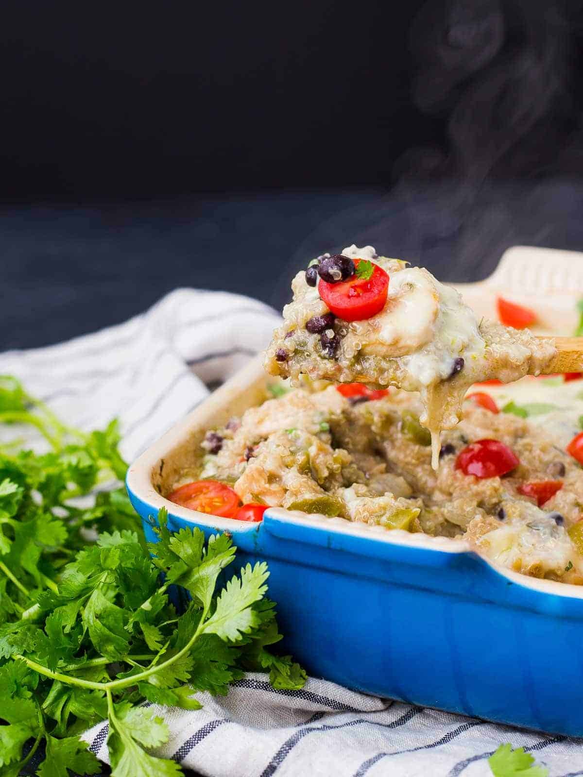 Partial image of baked casserole, with spoon lifting a portion out.