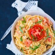 Fresh tomato cream sauce tossed with angel hair pasta is the perfect spring and summer pasta. It's easy to make and is the perfect side next to grilled chicken or fish. Get the easy pasta recipe on RachelCooks.com!