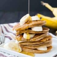 These easy and healthy banana pancakes taste just like banana bread in a whole wheat pancake form! They freeze well and will make mornings delicious! Get the healthy pancake recipe on RachelCooks.com!