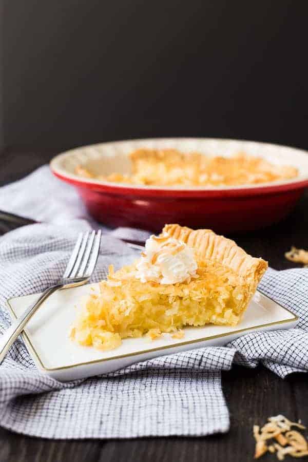 Slice of coconut custard pie on a plate.