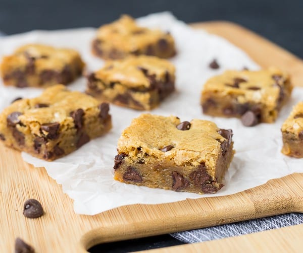 Blondies on a wooden cookie board.