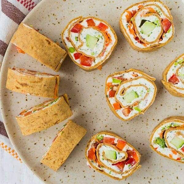 These vegetable cream cheese roll ups are full of crisp vegetables, flavorful herbs, and smooth cream cheese. They make a great lunch or snack thanks to extra protein in the wrap! Get the easy recipe on RachelCooks.com!