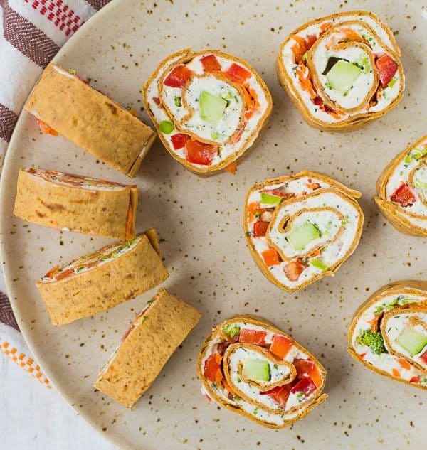 These vegetable cream cheese roll ups are full of crisp vegetables, flavorful herbs, and smooth cream cheese. They make a great lunch or snack thanks to extra protein in the wrap! Get the easy recipe on RachelCooks.com!