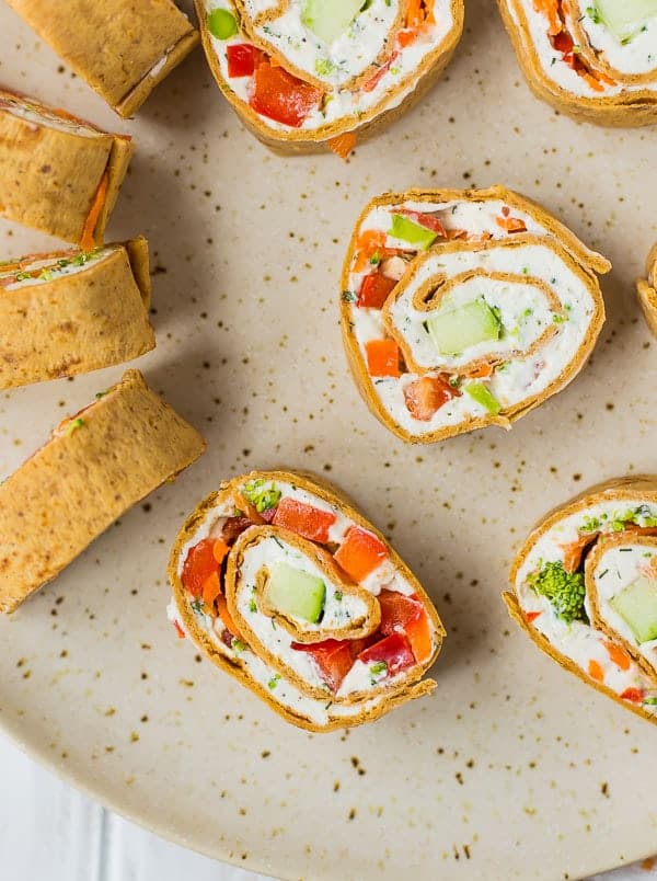 Vegetable cream cheese rolls ups sliced to show filling.