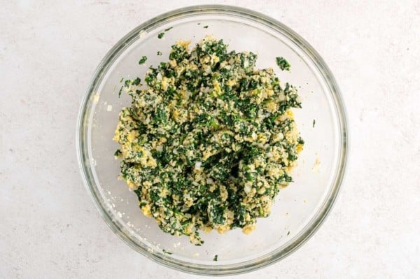 Spinach ball mixture in a glass bowl.