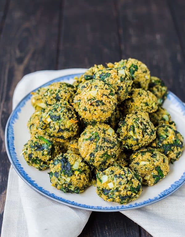Spinach Balls are great hot out of the oven but are also great as they cool to room temperature, making them a perfect appetizer! Always a huge hit! Get the healthier version of this appetizer recipe on RachelCooks.com!