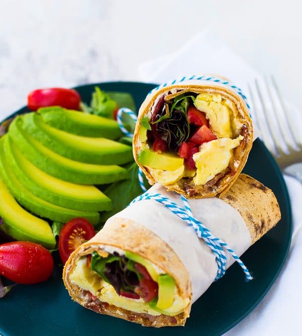 This California Breakfast Wrap is great for breakfast or lunch! The salty bacon, creamy avocado, fresh tomatoes and filling eggs make it a perfect meal! Get the easy recipe on RachelCooks.com!
