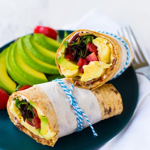 This California Breakfast Wrap is great for breakfast or lunch! The salty bacon, creamy avocado, fresh tomatoes and filling eggs make it a perfect meal! Get the easy recipe on RachelCooks.com!