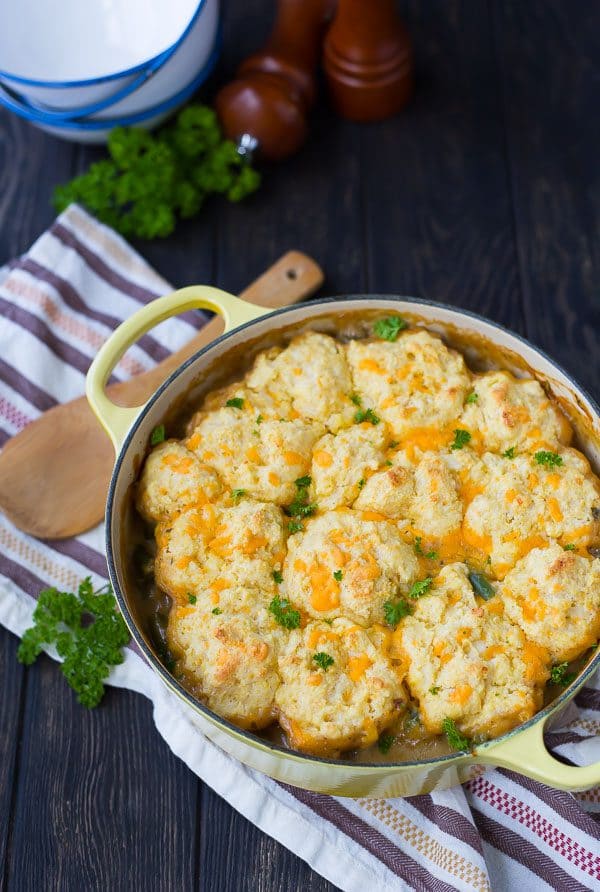 Overhead of Dutch oven filled with chicken stew, garnished with fresh parsley.