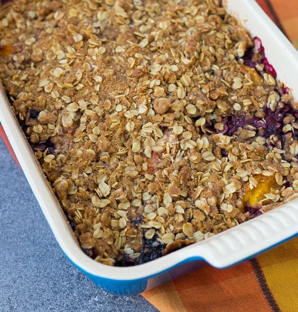 This peach blueberry crisp can be made with fresh or frozen fruit, making it a perfect dessert all year round! It's perfect with a scoop of vanilla ice cream.  Get the easy recipe on RachelCooks.Com!