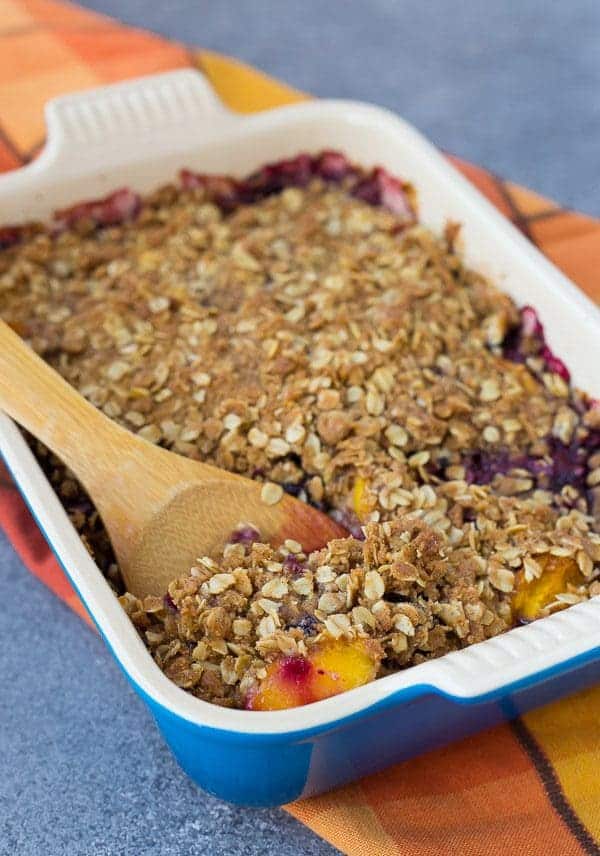 This peach blueberry crisp can be made with fresh or frozen fruit, making it a perfect dessert all year round! It's perfect with a scoop of vanilla ice cream.  Get the easy recipe on RachelCooks.Com!