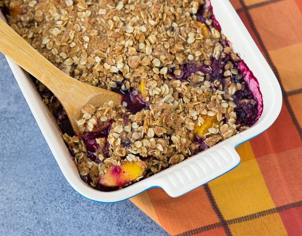 This peach blueberry crisp can be made with fresh or frozen fruit, making it a perfect dessert all year round! It's perfect with a scoop of vanilla ice cream.  Get the easy recipe on RachelCooks.Com!