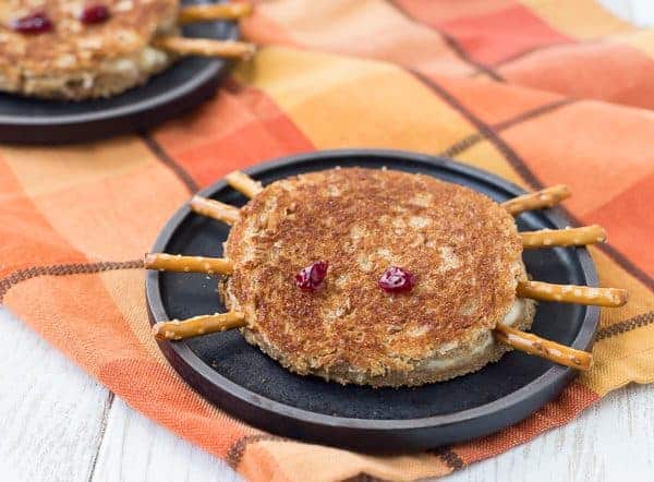 Closeup of spider sandwich on black plate.