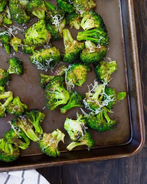 Partial overhead view of sheet pan containing roasted broccoli.