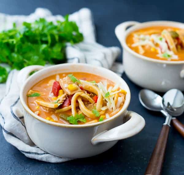 A bowl of soup, garnished with fresh cilantro.